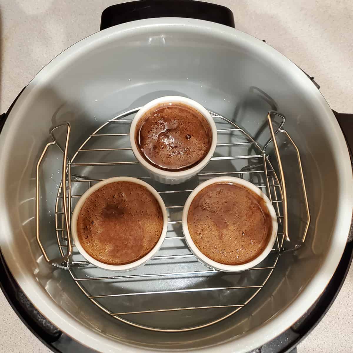 Chocolate custard ramekins on trivet