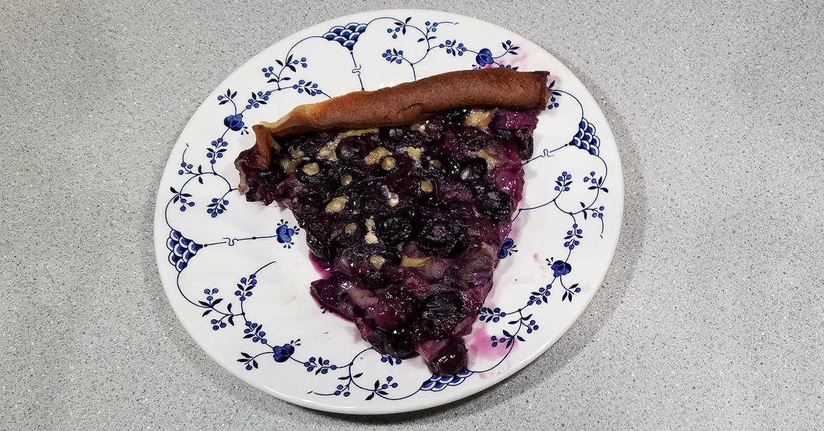 Blueverry Clafoutis a slice on a plate