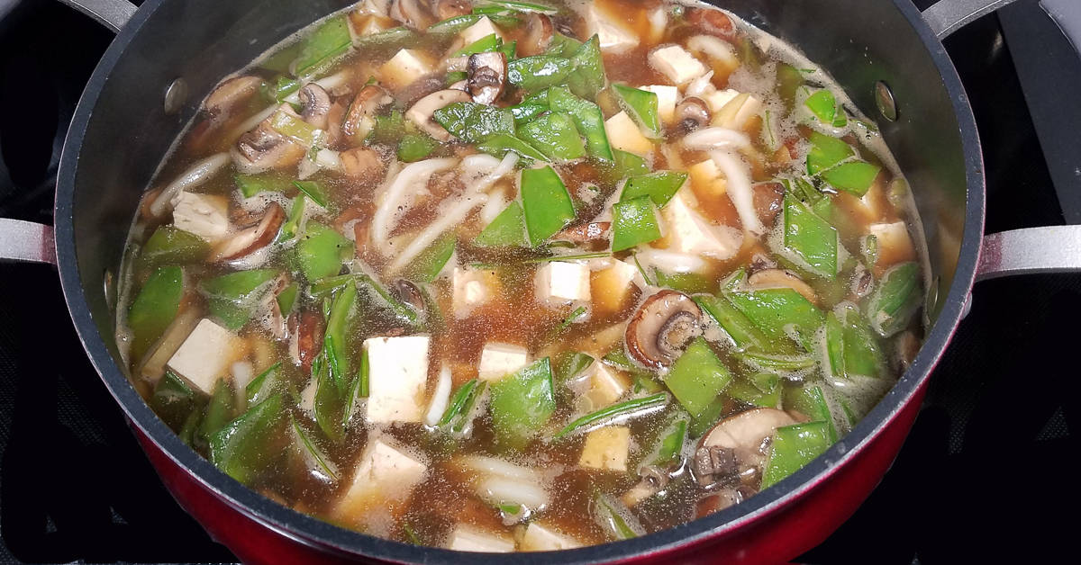 Beef Ginger Soup with Udon Noodles and Snow Peas mushrooms and show peas added to soup