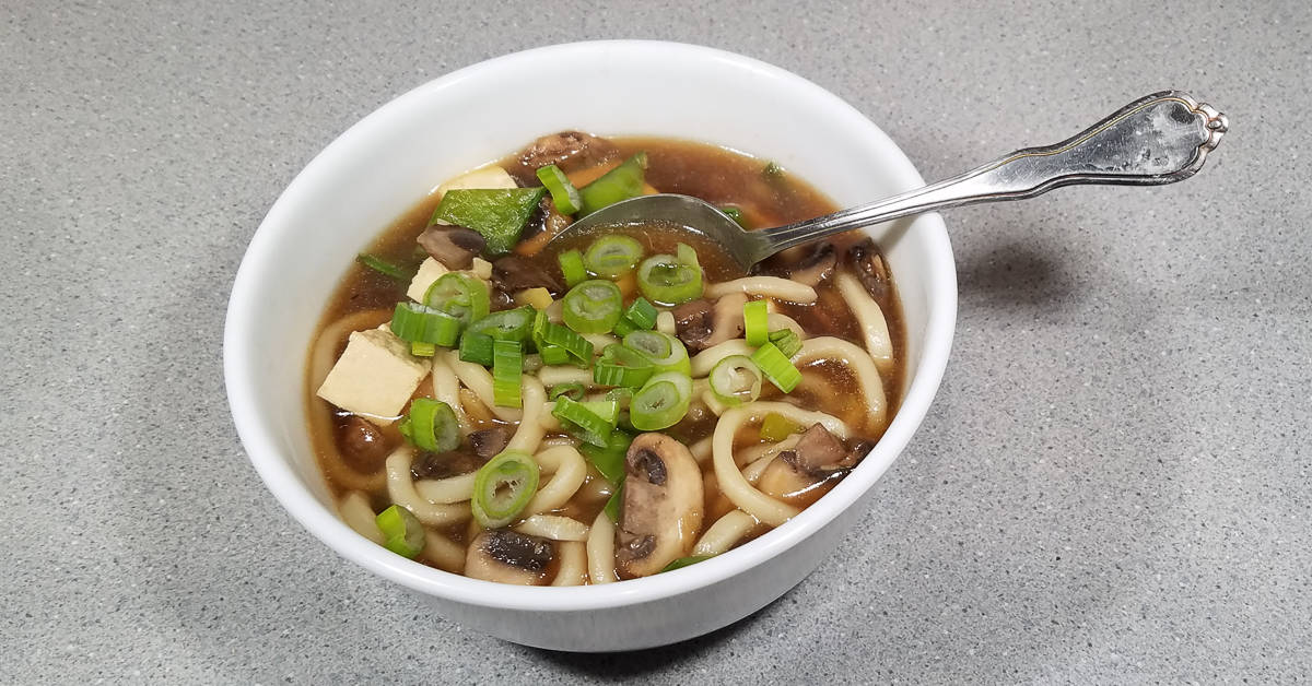 Beef Ginger Soup with Udon Noodles and Snow Peas served in a bowl