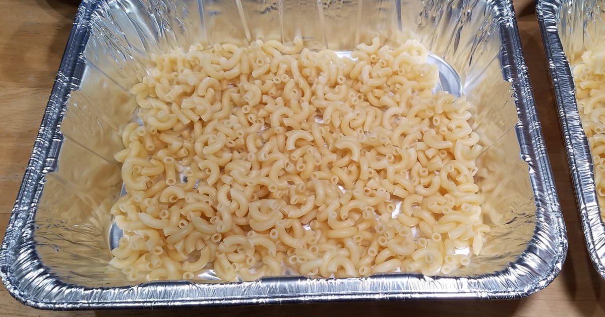 Cheesy Kielbasa Casserole layer of pasta in baking pan