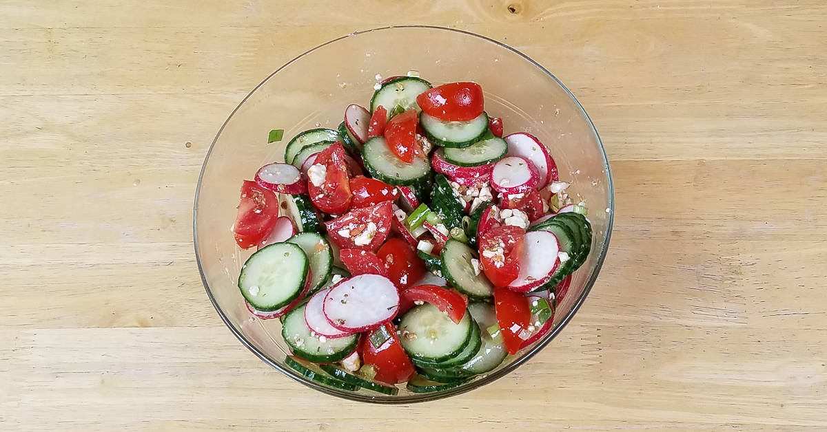 Cucumber Tomato and Radish Salad vegetables tossed with dressing