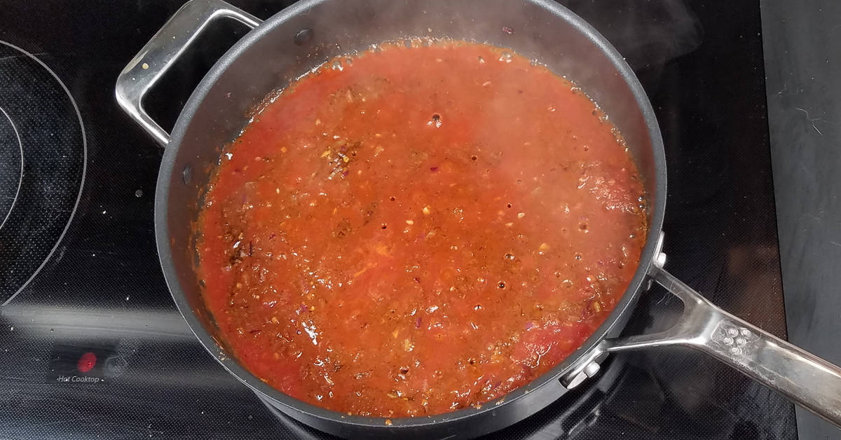 Indian Spiced Chicken Casserole adding tomato sauce