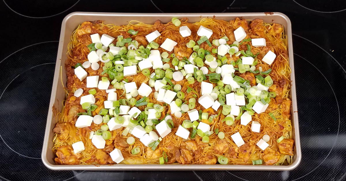 Indian Spiced Chicken Casserole topped with paneer and green onions