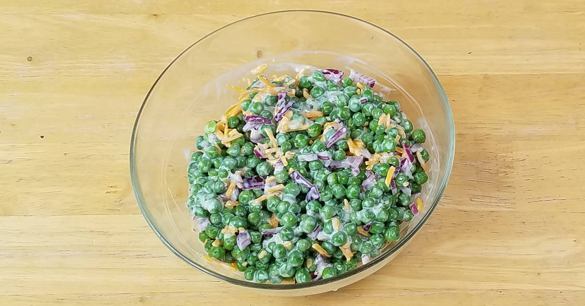 Pea Salad With Bacon ingredients mixed in a bowl