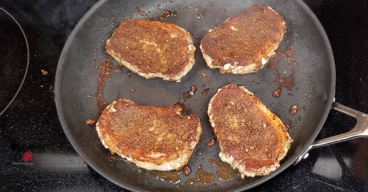 Spice Rubbed Pork Chops flipped and frying other side