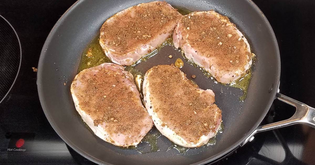 Spice Rubbed Pork Chops frying in the pan