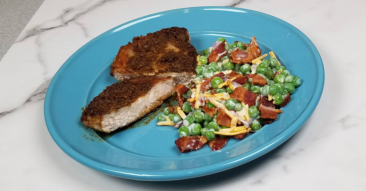 Spice Rubbed Pork Chops served with pea salad