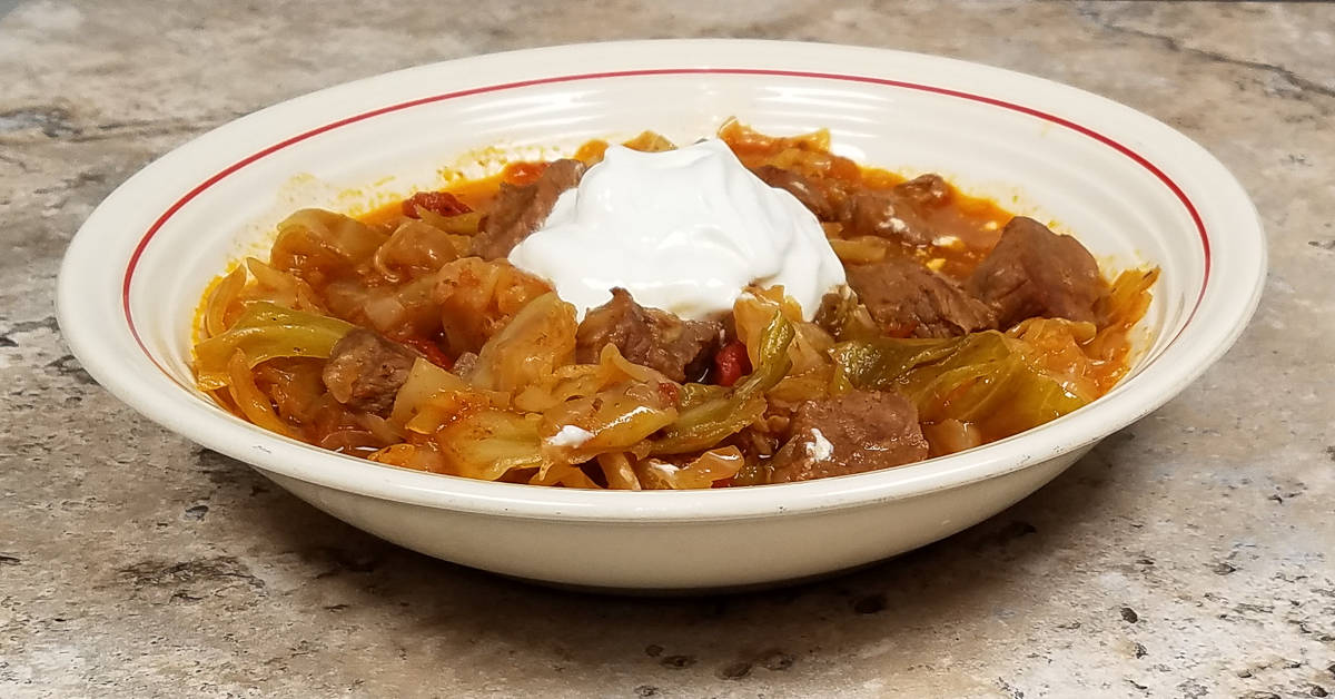Turkish Beef and Cabbage in a bowl with sour cream