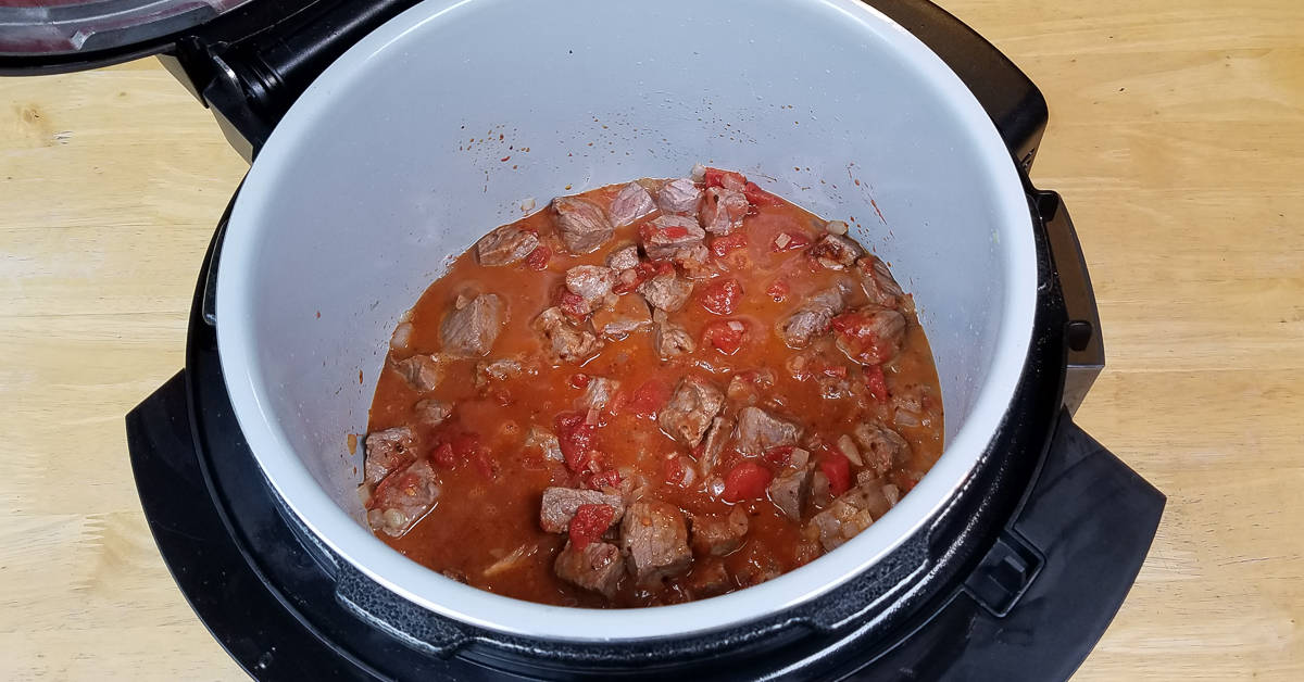 Turkish Beef and Cabbage tomatoes and seasoning added to pot