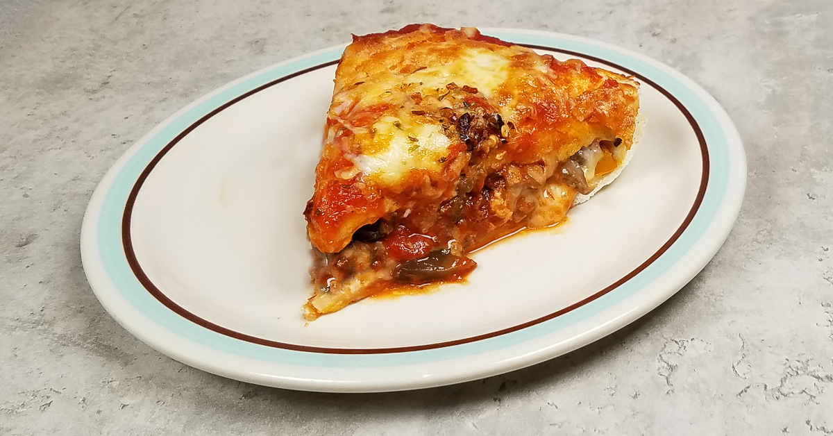 Chicago Style Stuffed Pizza slice on a plate