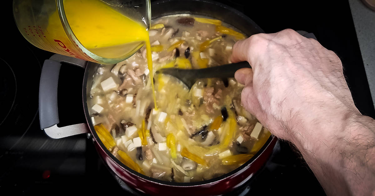 Hot and Sour Soup stirring egg into soup