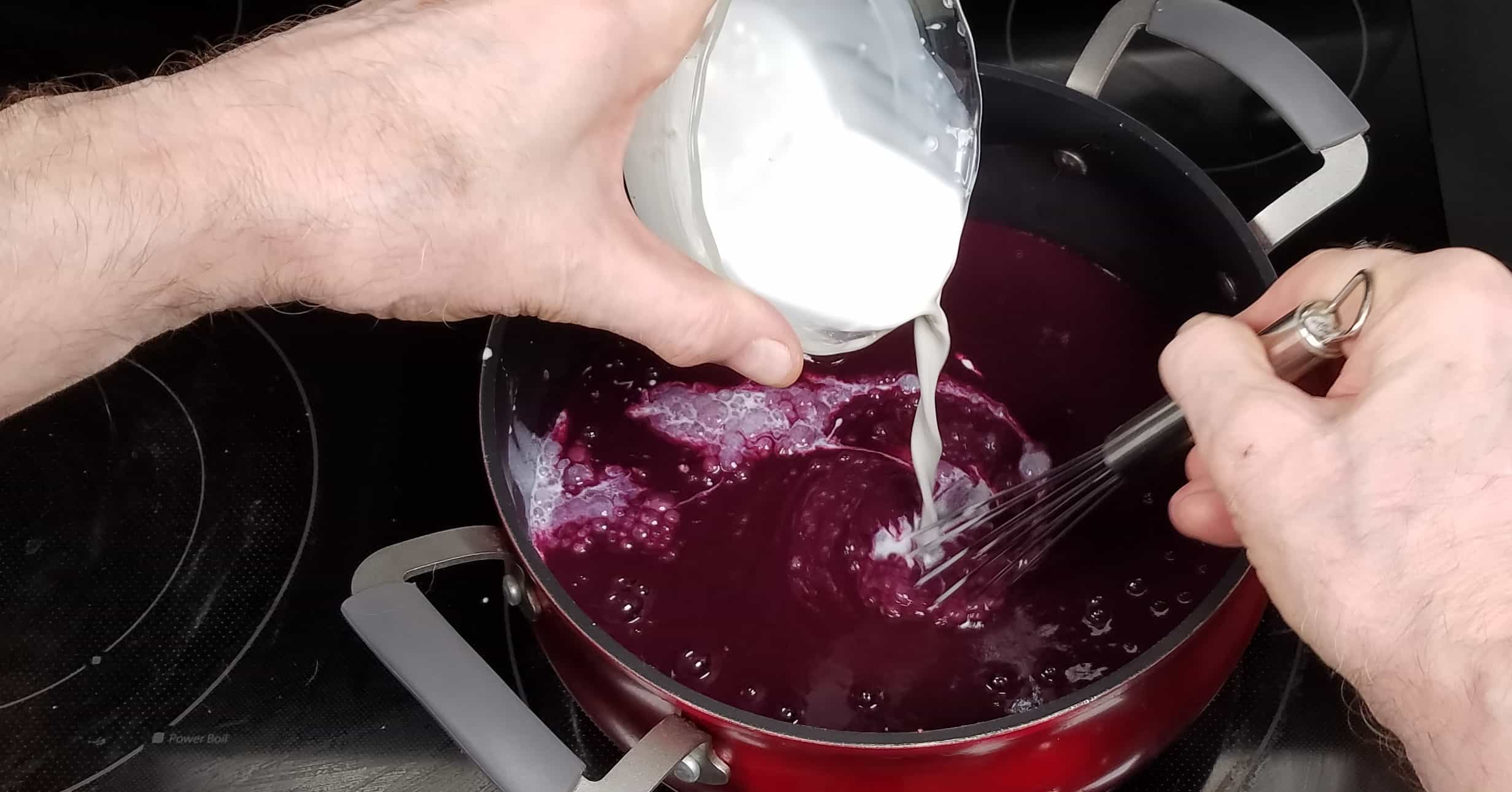Spiced Blueberry Soup whisking cornstarch slurry into soup