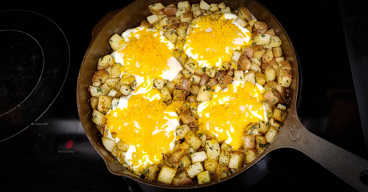 Pan Fried Potatoes and Eggs tooped with cheese