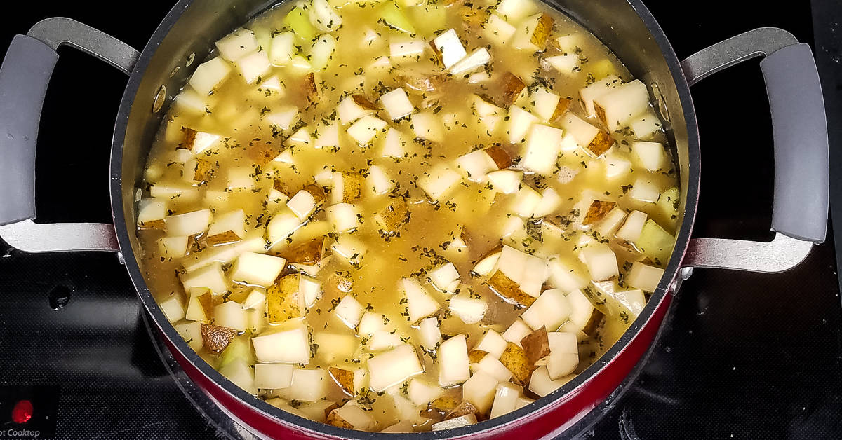 Creamy Zucchini Soup stock and potatoes added to pot