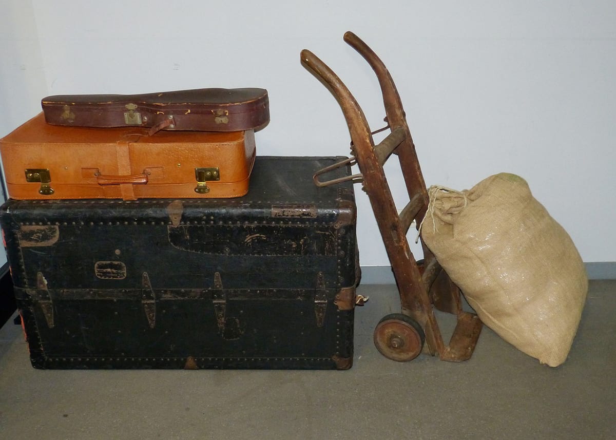 Suitcases and hand cart.