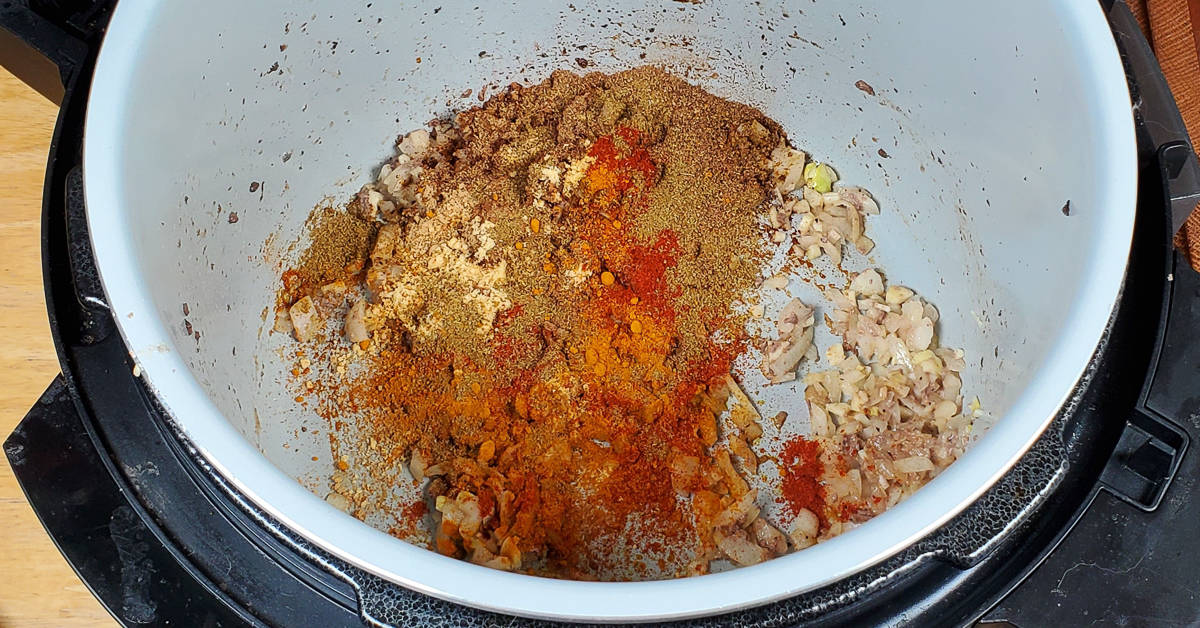 Beef Vindaloo spices added to pot.