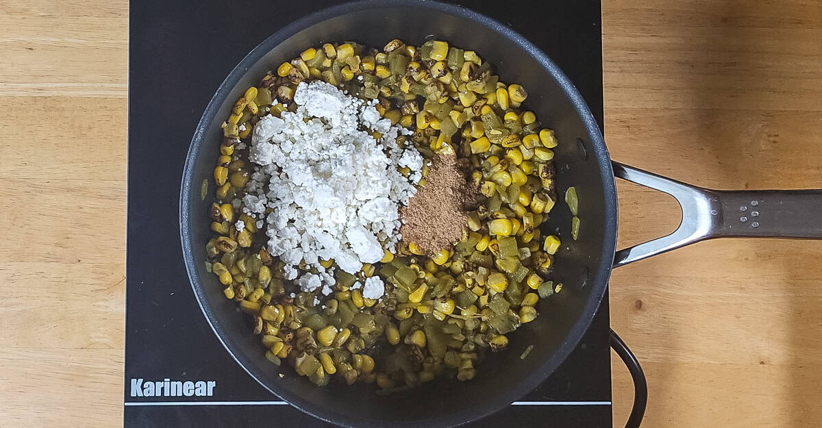 Hatch Chile Corn goat cheese and spices affed to the pan