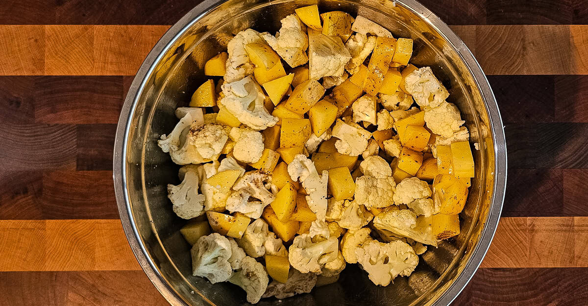 Sheet Pan Chicken Vindaloo potatoes and cauliflower in a bowl