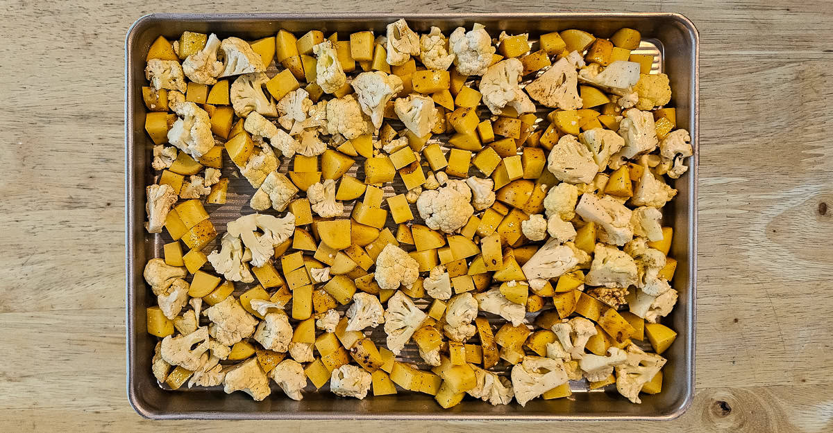 Sheet Pan Chicken Vindaloo potatoes and cualiflower in the pan