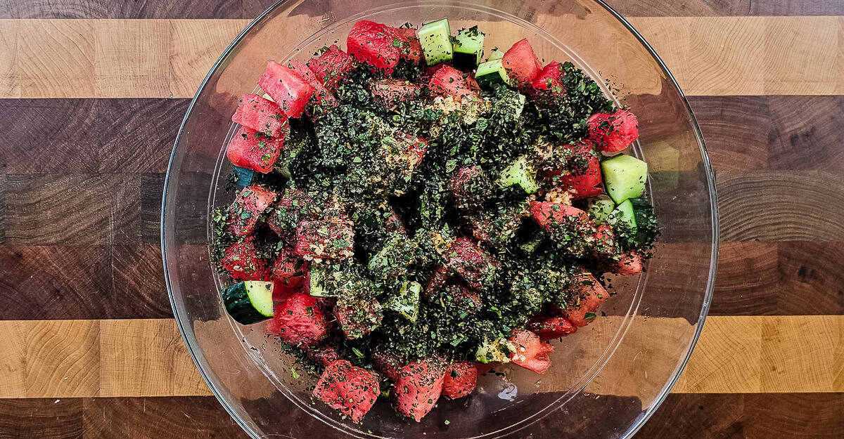 Watermelon and Cucumber Salad mint added to the bowl