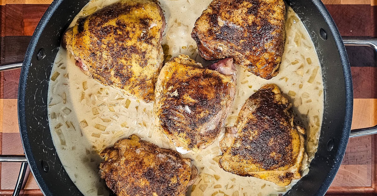 Indian Spiced Chicken Thighs With Coconut Rice chicken returned to the pan