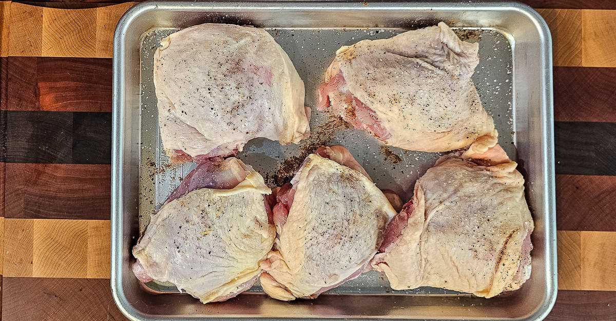 Indian Spiced Chicken Thighs With Coconut Rice chicken seasoned with salt and pepper