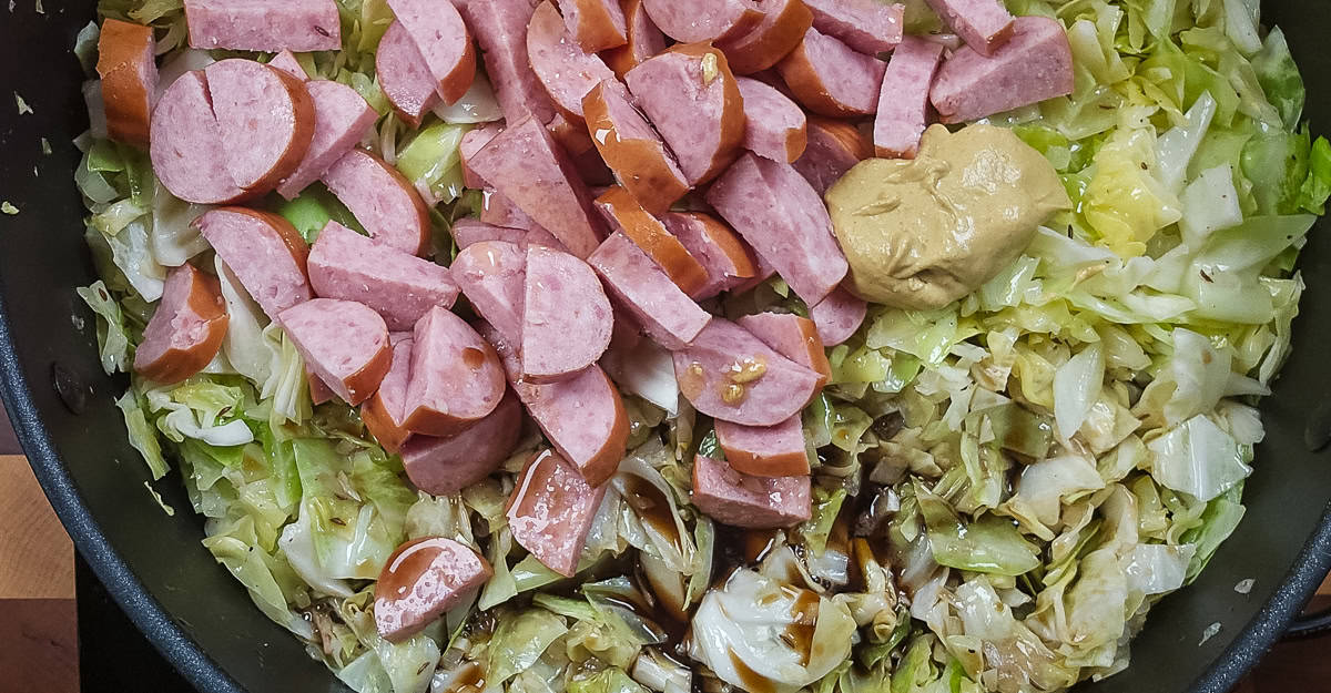 Kielbasa, Cabbage, and Apple Skillet Dinner kielbasa, mustard, and brown ale added to the pan