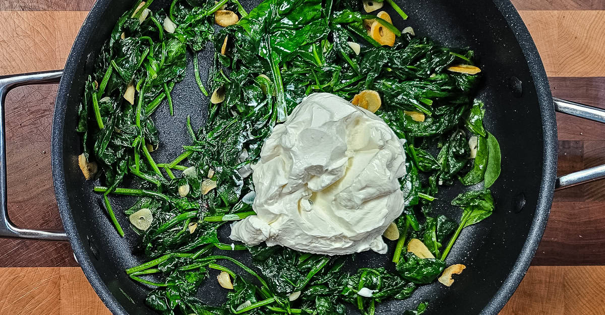 Sautéed Spinach With Garlic and Sour Cream adding sour cream to the pan